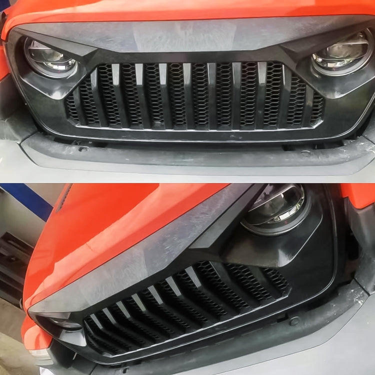 Installed black front grille insert with insect-mesh grid on vehicle bumper