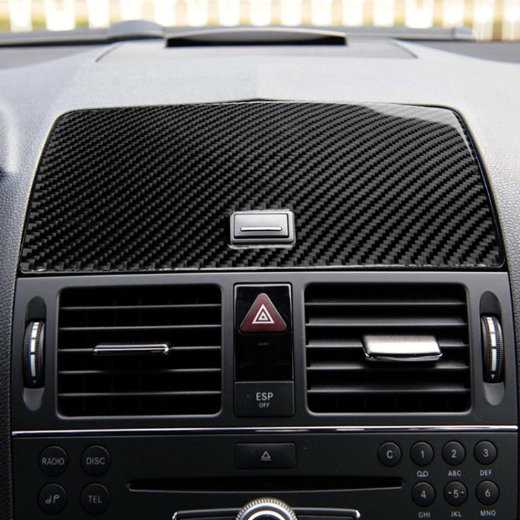 Carbon fiber console navigation panel insert with square cutout on car dashboard
