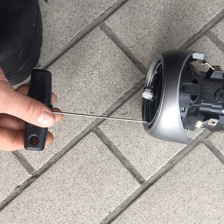 Car air outlet removal tool prying at dashboard trim around vent housing