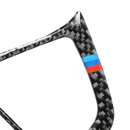 Carbon-fiber steering wheel button trim piece with blue and red stripe, close-up corner
