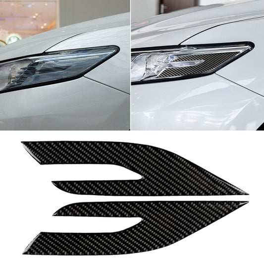 Black carbon fiber headlight decorative sticker applied to a car headlight lens