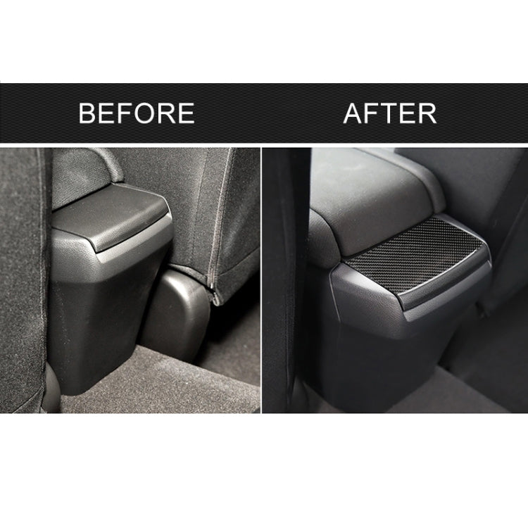Rear console area with black carbon fiber patterned cover sticker on seat