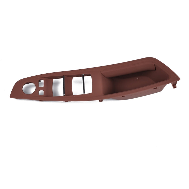 Brown front door handle window switch panel with switch cutouts and chrome trim