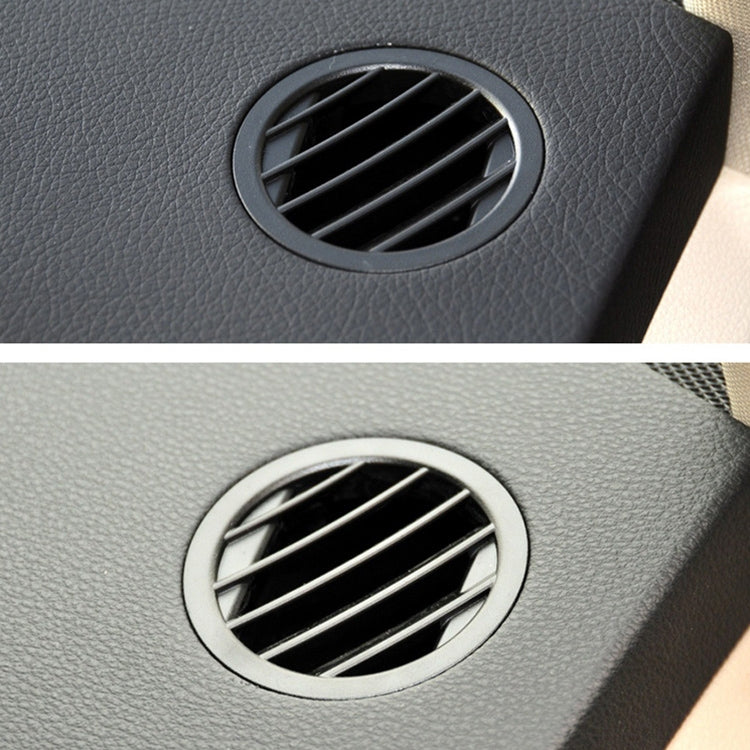 Circular dashboard air vent shown in dark and light trim with silver outer ring
