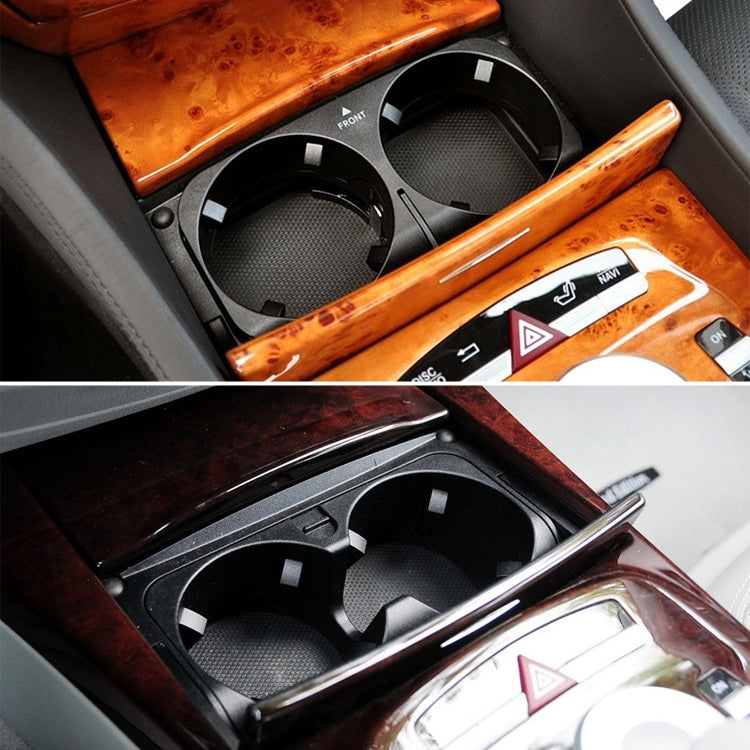 Installed black dual cup holder insert in center console with wood trim