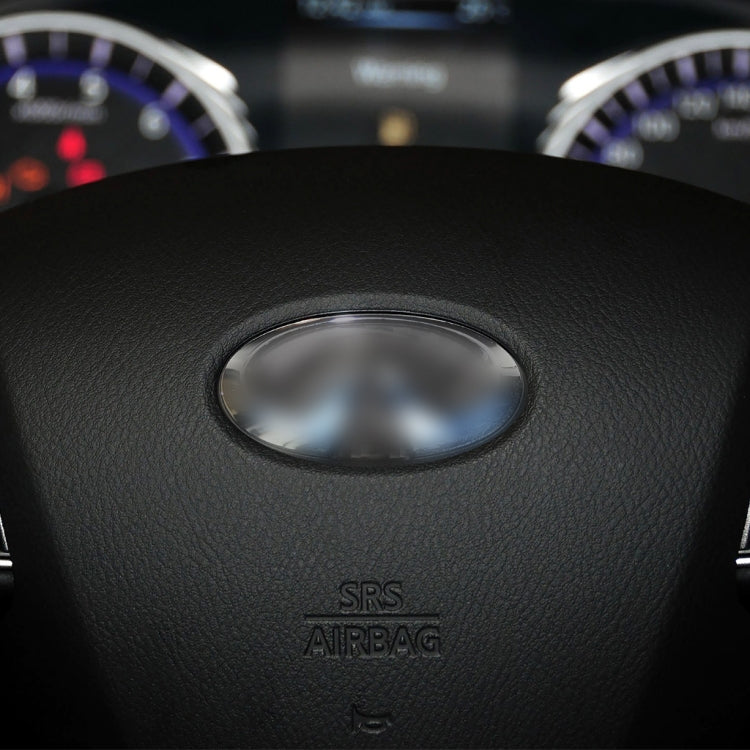 Steering wheel center pad with oval airbag cover and SRS airbag text