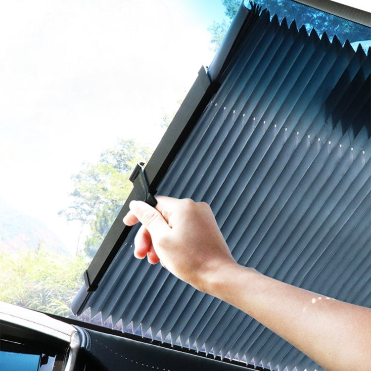 Windshield sun shade being attached to window frame, pleated dark panel
