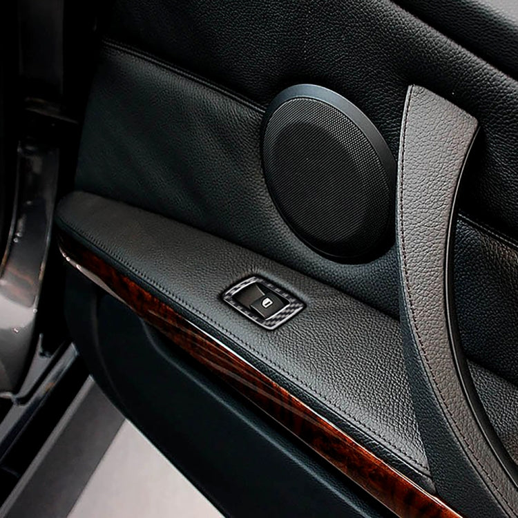 Carbon fiber door trim close-up with window switch panel and speaker surround