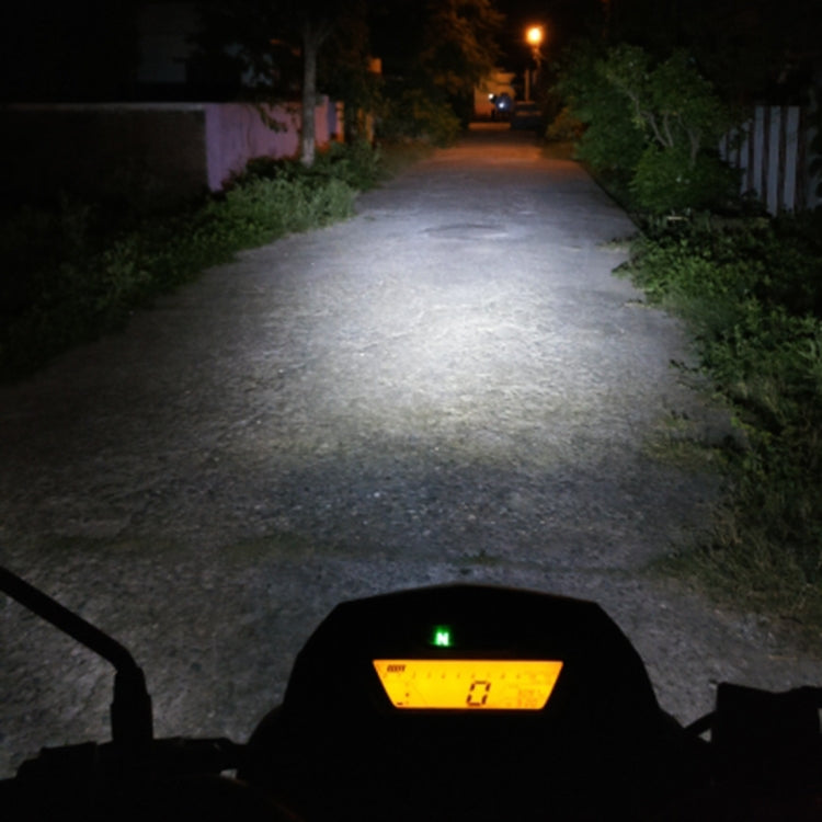 H4 LED headlight beam illuminating a path at night, view from rider cockpit