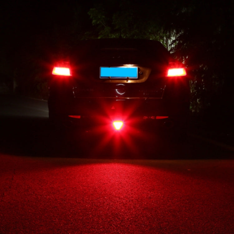 Center red triangular LED light glowing on the rear of a car