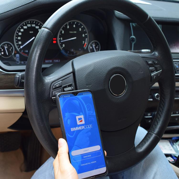 Car dashboard setup with Vgate VLinker MC+ Bluetooth app on a smartphone screen