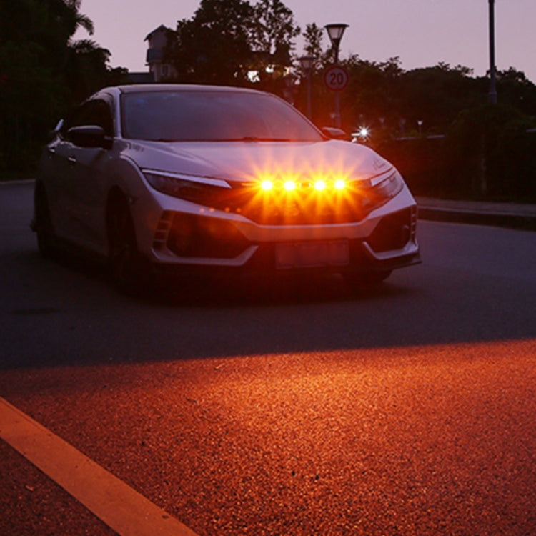 Amber/yellow front grille warning lights glowing on a parked vehicle