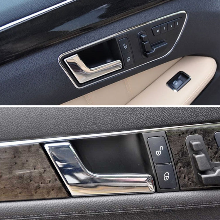 Bright chrome inner door handle panel inside car door near window switch