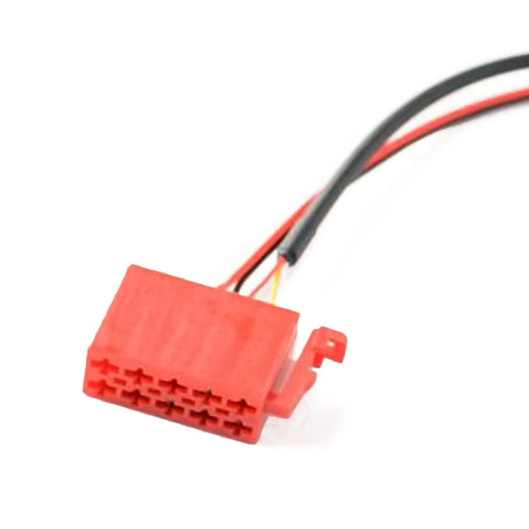 Car audio wiring harness with red connector block and attached multicolor wires.