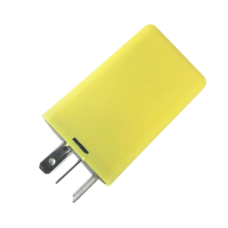 Yellow indicator relay with two metal prongs on underside and black side notch.