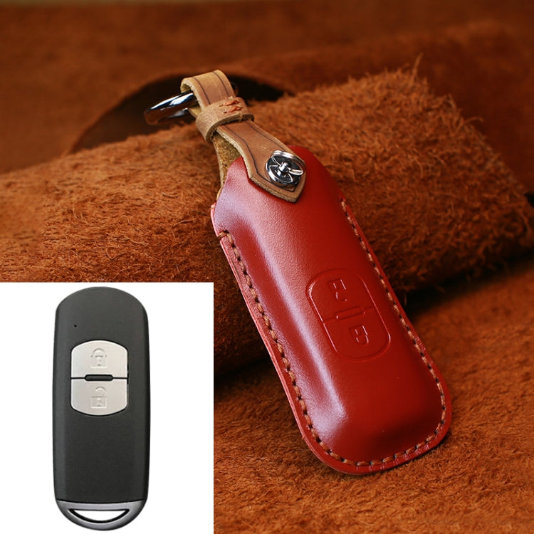 Red leather key protective cover with metal keyring, stitched edges, embossed button panel