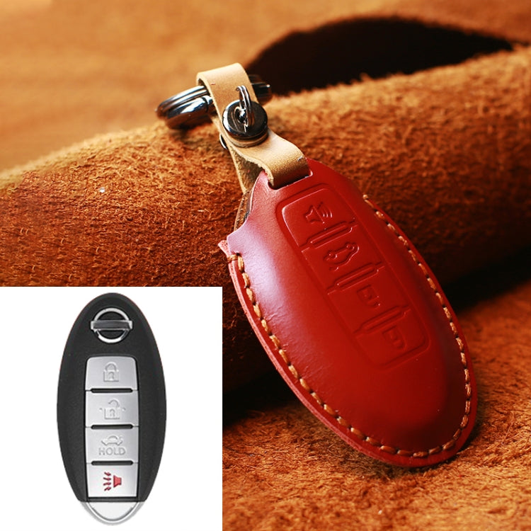 Red leather key fob cover with metal key ring, tan strap, and stitched edges