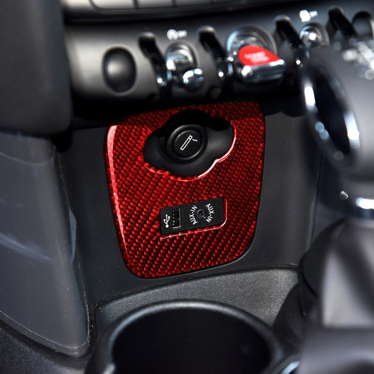 Red carbon-fiber cigarette lighter cover installed on car dashboard with controls nearby