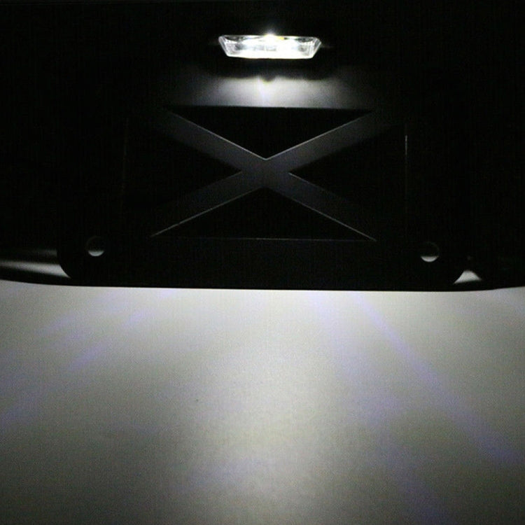 Black motorcycle license plate holder with illuminated LED light in dark