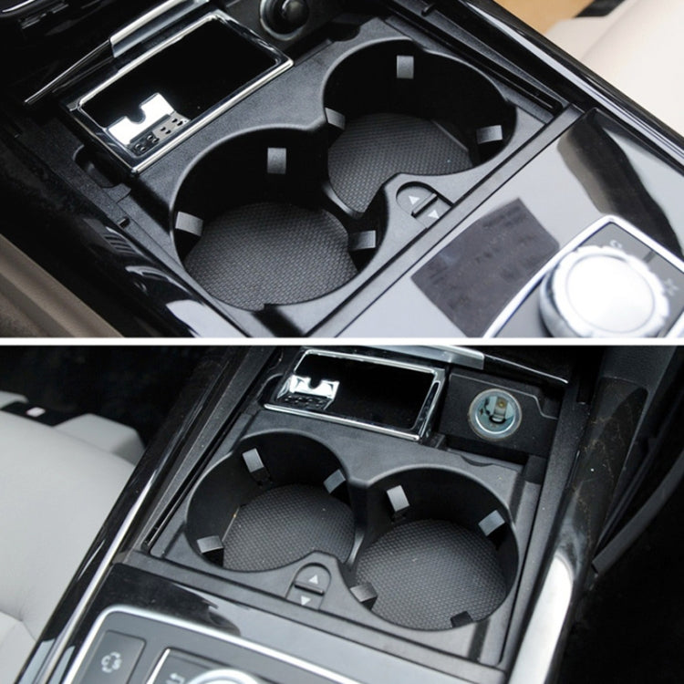 Dual cup holders in car center console, black insert with two circular openings