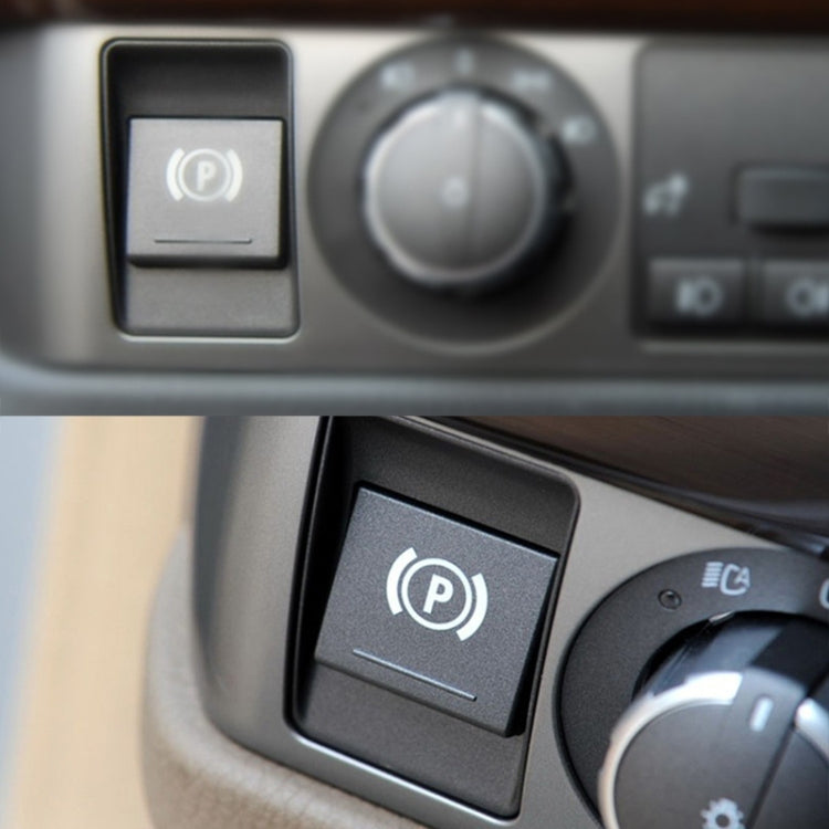 Close-up auto parking switch cover button with “P” icon on dark trim panel
