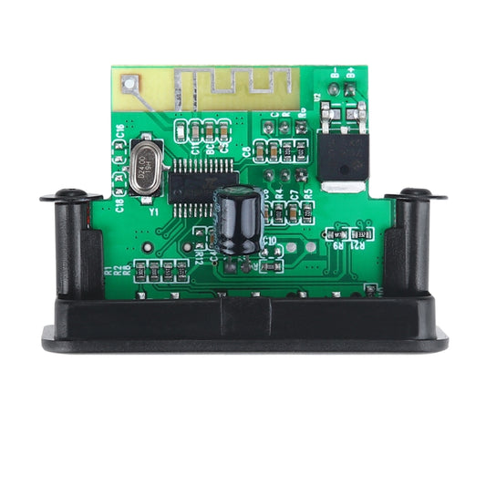 Green PCB car audio decoder board with components and ICs on a black base