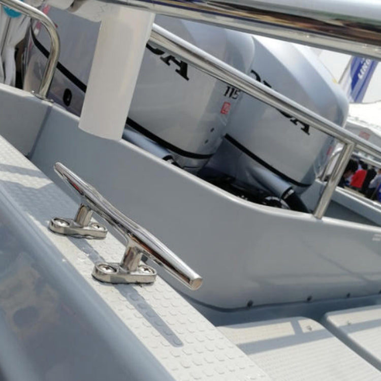 Mounted stainless steel boat cleat with two base plates on deck