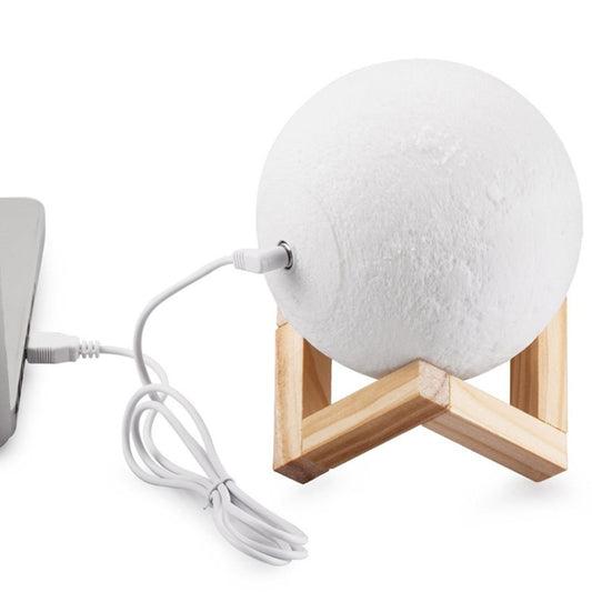 White moon LED lamp on wooden stand with attached USB charging cable