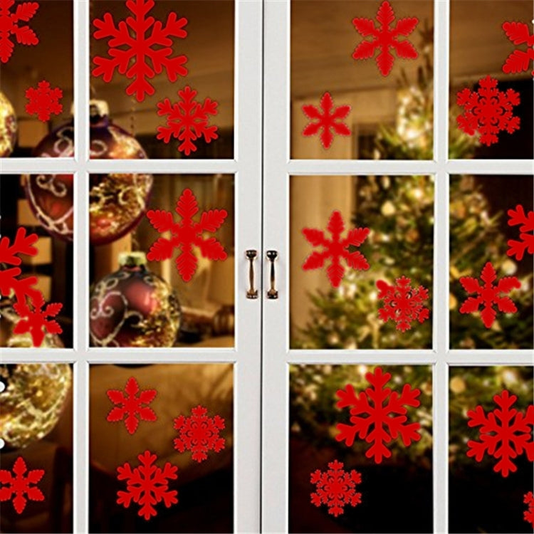 Window snowflake sticker set with red snowflake decals in varied sizes on glass grid