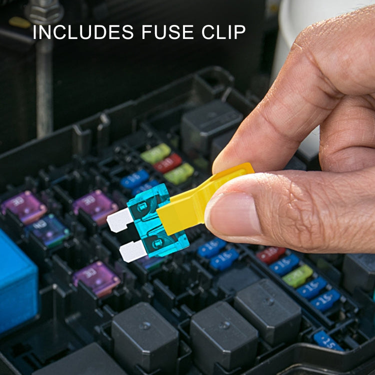 Hand holding a yellow fuse clip to remove a colored car blade fuse from the box.