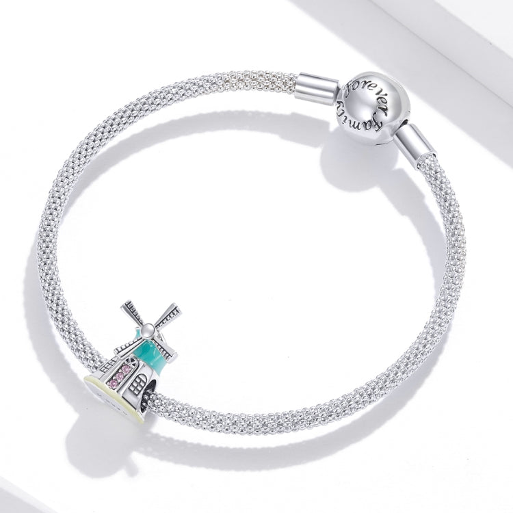 Silver bracelet with mesh chain and windmill charm bead in teal enamel, pink CZ