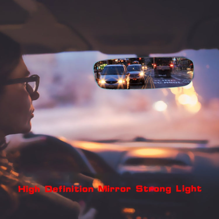 Curved frameless rearview mirror reflecting night traffic from inside car