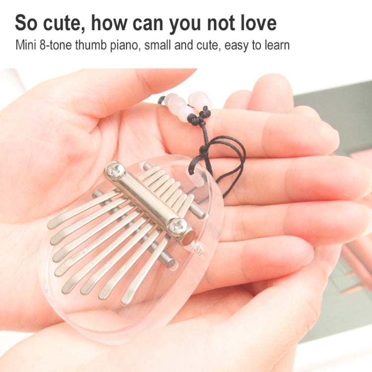 Mini kalimba thumb piano with metal tines held in a hand