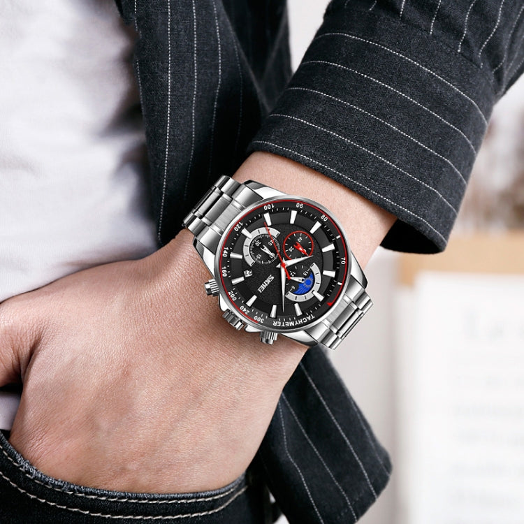 Men's moonphase stopwatch quartz watch on wrist with silver bracelet and black dial