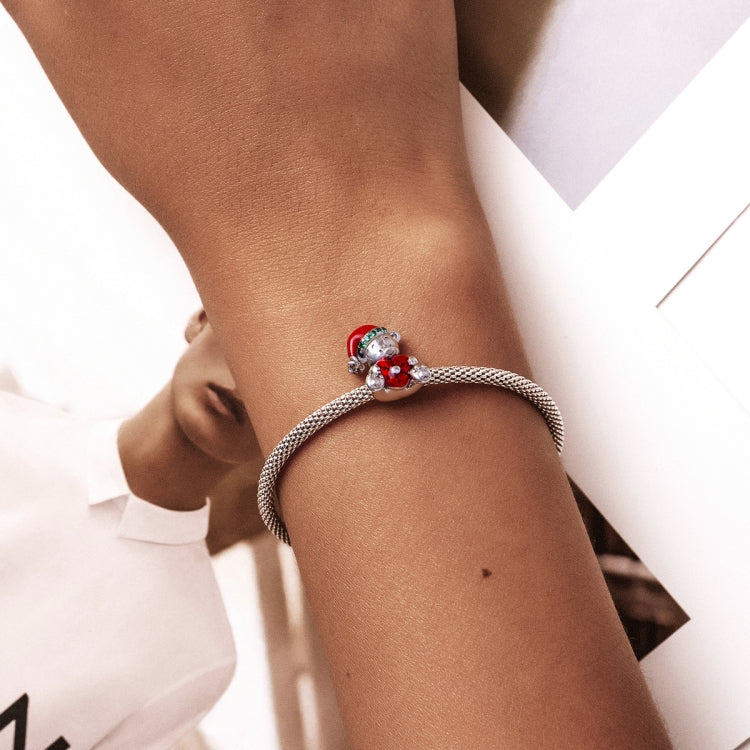 Wrist-worn bracelet with silver chain and red enamel bear charm bead