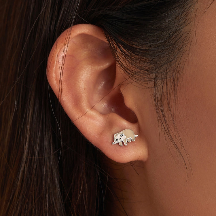 Closeup of silver sloth stud earrings with enamel body detail on the ear