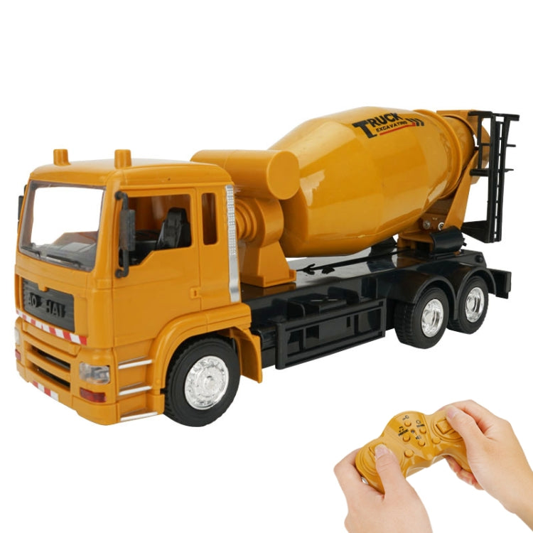 Yellow remote control concrete mixer truck with rotating drum and hand-held controller