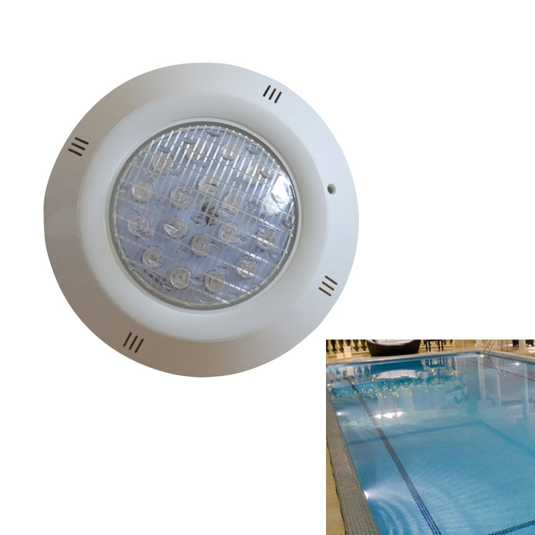 White round LED underwater pool wall lamp with clear front lens, installed by pool water