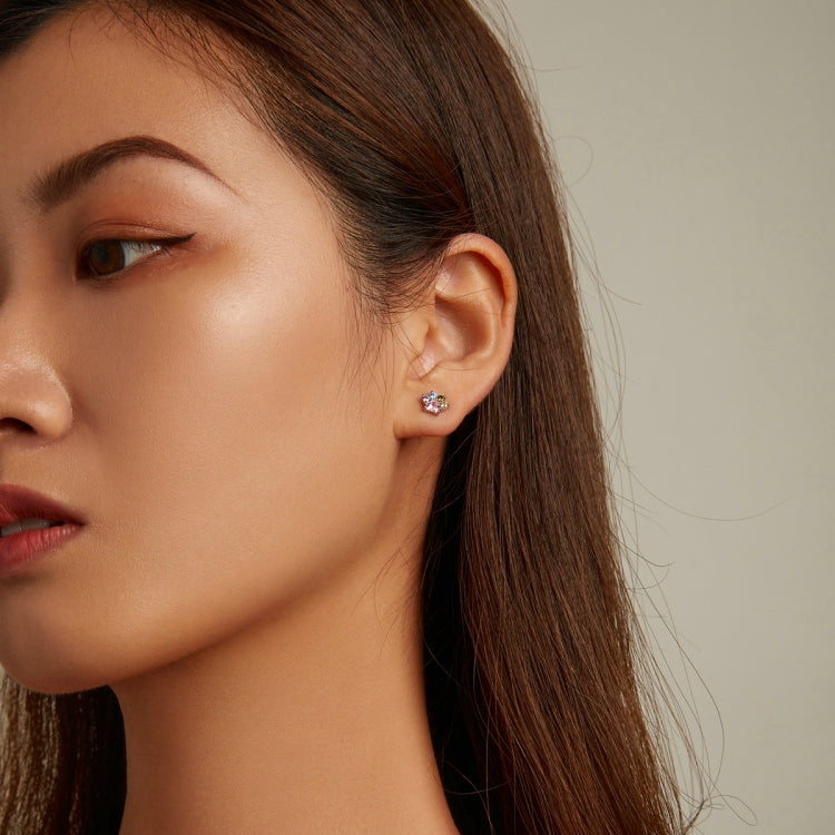 Zircon cluster ear stud on model’s ear with pink center and multicolor sparkle stones