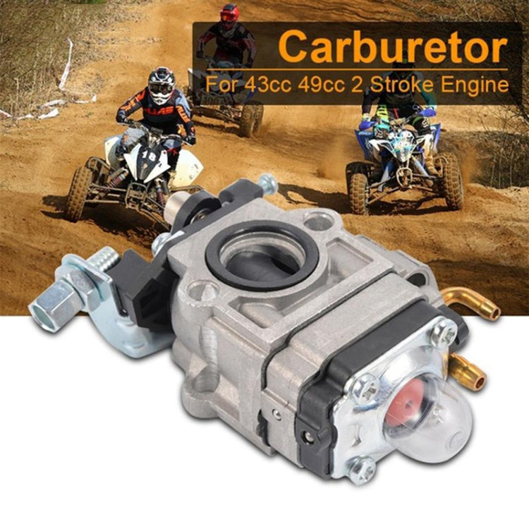 Two-stroke carburetor unit with silver housing, black top cover, and twin fuel fittings