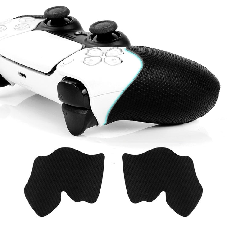Anti-slip controller grip stickers on white controller handles, two black pads