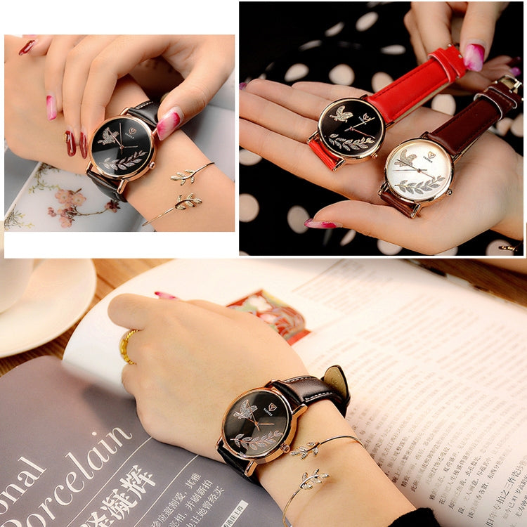 Round wristwatch with black face and black strap; red-strap watch shown on wrists