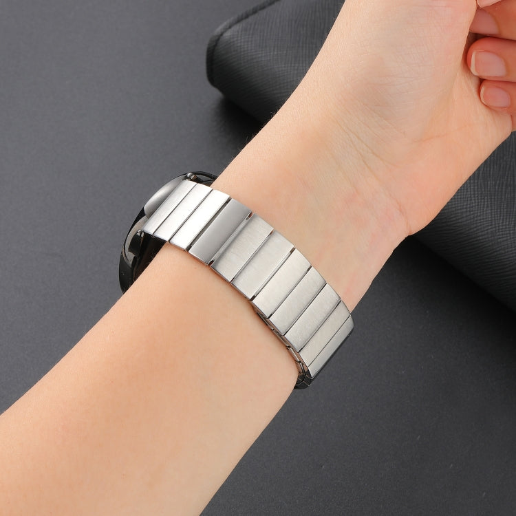 Magnetic steel watch band in silver on wrist, close-up of metal link fit