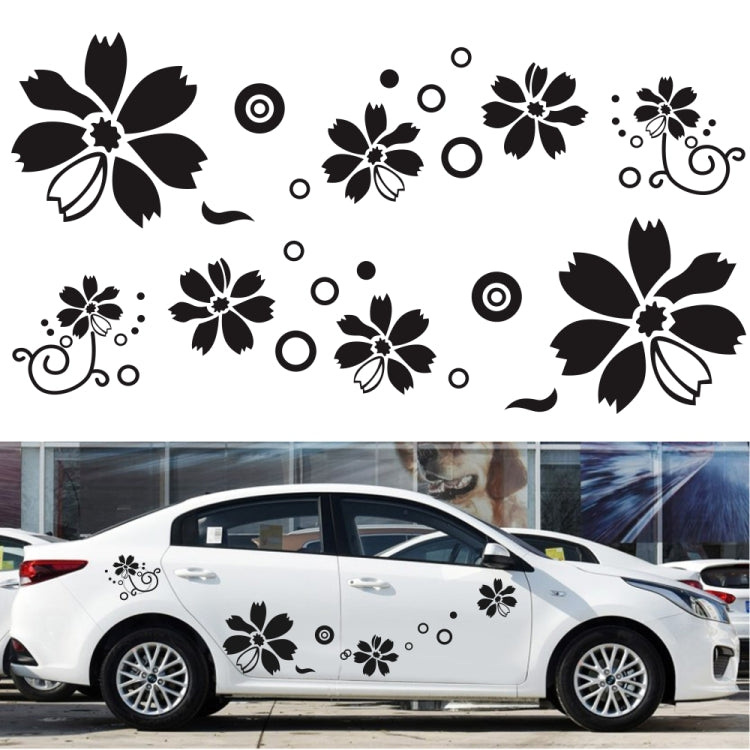 White car with black flower and swirl decorative stickers along the doors