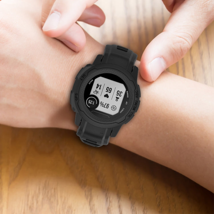 Silicone sports watch band in dark color on wrist, close-up view