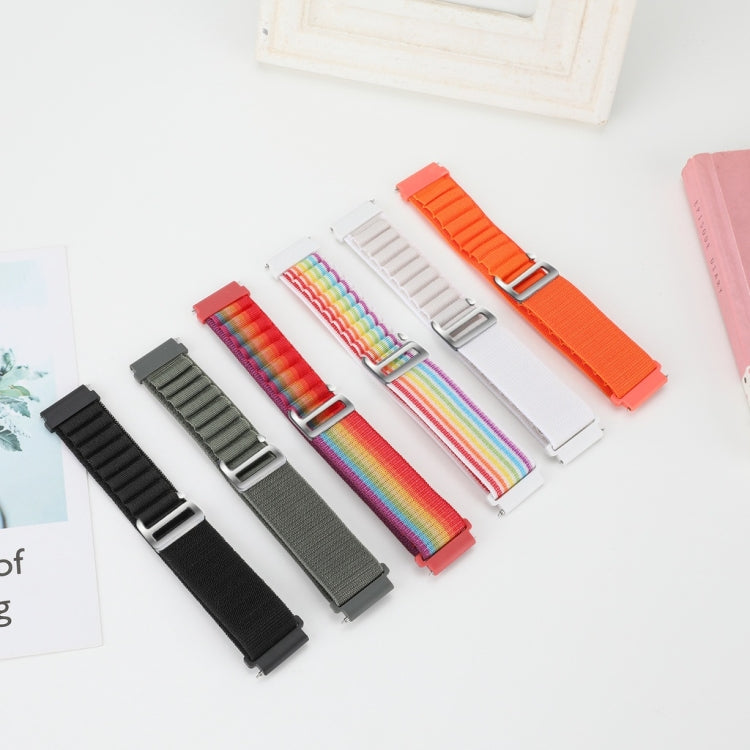 Set of nylon watch bands in black, gray, white, and rainbow with metal clasps.