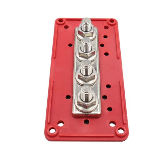 Red 4-way terminal busbar base with four M10 stud screws on metal contact strip