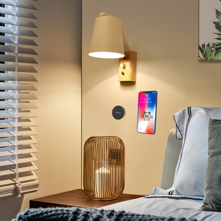 Round magnetic phone holder plate on wall holding a smartphone indoors