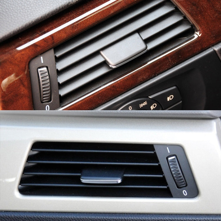 Black A/C air vent grille in car dashboard with central control tab and louvers