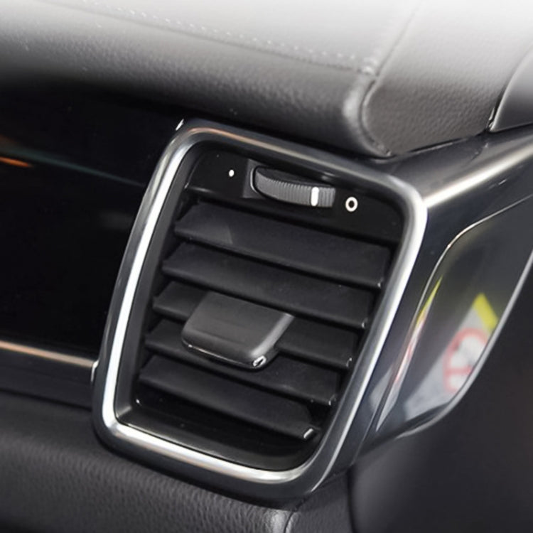 Close-up of black AC air vent with chrome bezel and horizontal airflow slats